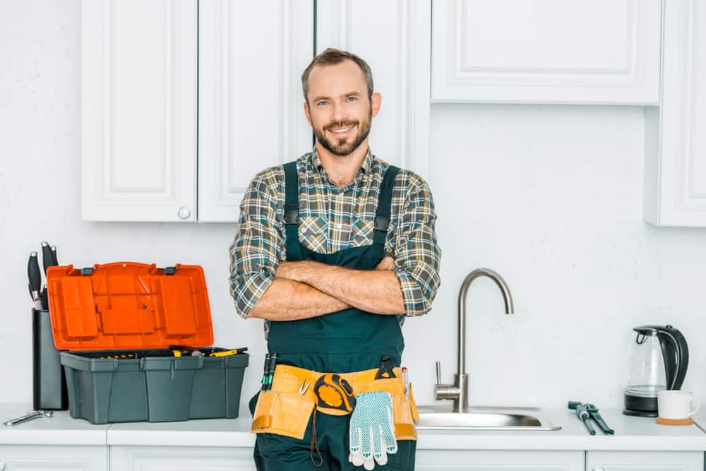 Smiling Handsome Plumber Standing With Crossed Arms